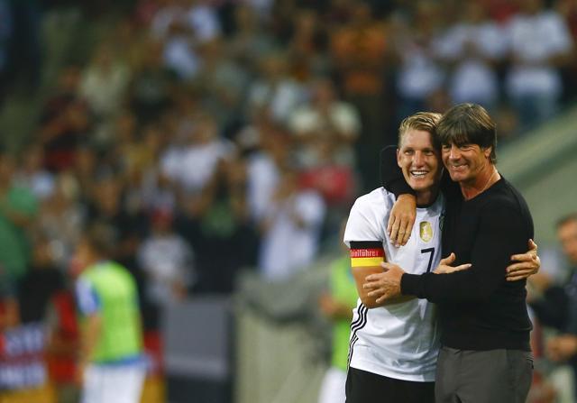 Schweinsteiger hugs German coach Joachim Loew. (REUTERS)