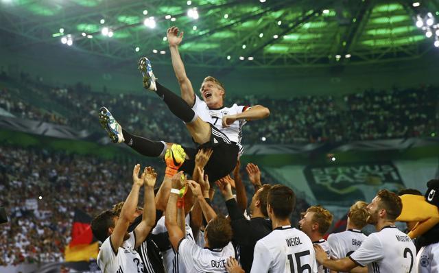 Germany's Bastian Schweinsteiger honoured by teammates after the match. (REUTERS)