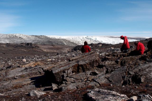 This undated handout picture released on September 1, 2016 by the University of Wollongong shows team members Vickie Bennett (L), Allen Nutman (C) and Clark Friend examining rocks in Greenland, where 3.7 billion year old stromatolite fossils were found. (AFP)