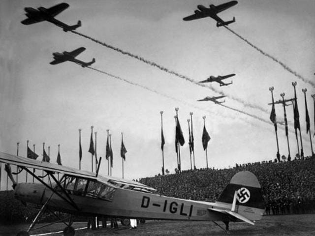German planes fly above the crowd during an air show as part of a military parade in Germany, in 1938. From 1938, Hitler, as chief of the Wehrmacht (German army), launched the conquest of the ‘vital space’ for "Greater Germany". He annexed Austria and Czechoslovakia in 1938, and Poland in 1939, which started World War II. (AFP Archive)