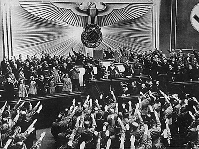 Then German Nazi chancellor Adolf Hitler (centre) receives an ovation from the Reichstag and members of Parliament who give him the Nazi salute, for the “Anschluss” with Austria -- the ‘peaceful’ acquisition of Austria, in March 1938 in Berlin. (AFP Archive)