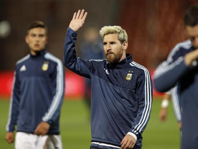 Argentina's Lionel Messi, center, waves to fans. (AP Photo)
