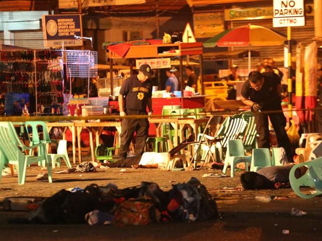 A Philippine soldier keeps watch at a blast site at a night market that has left several people dead in southern Davao city. (AP) A Philippine soldier keeps watch at a blast site at a night market that has left several people dead in southern Davao city. (AP)