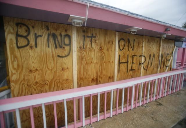 A hand painted sign on a boarded up bar is seen as Hurricane Hermine nears the Florida coast on Thursday. (AP)
