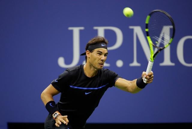 Rafael Nadal of Spain returns a shot to Andrey Kuznetsov. (AFP Photo)