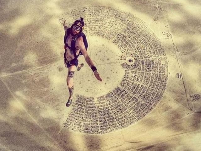 In recent years, people have started bringing drones to Burning Man - the annual arts fest at Nevada’s Black Rock Desert. Here’s a man parachuting into the venue.