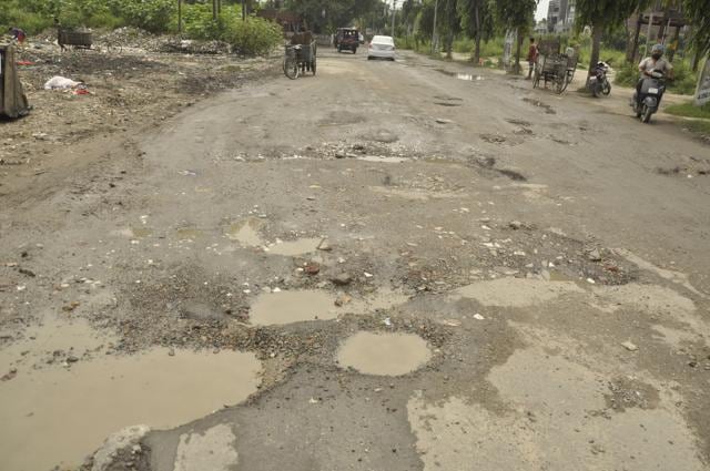 Potholes on a road in the posh locality of Urban Estate phase 2 in Jalandhar on Friday. (Sikander Singh Chopra/HT Photo)