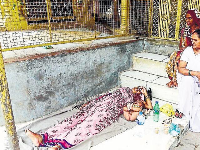 Urmila, along with her baby, lying on the road after she was thrown out of the district hospital ward in Chattarpur. Urmila, along with her baby, lying on the road after she was thrown out of the district hospital ward in Chattarpur.
