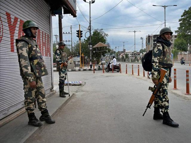Security personnel stand guard during curfew and strike in Srinagar. (PTI Photo) Security personnel stand guard during curfew and strike in Srinagar. (PTI Photo)