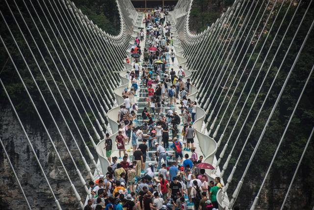 The bridge over a valley in Zhangjiajie in China's Hunan Province was opened on August 21, 2016. The glass-floored bridge is the world's longest and highest. (AFP File Photo) The bridge over a valley in Zhangjiajie in China's Hunan Province was opened on August 21, 2016. The glass-floored bridge is the world's longest and highest. (AFP File Photo)