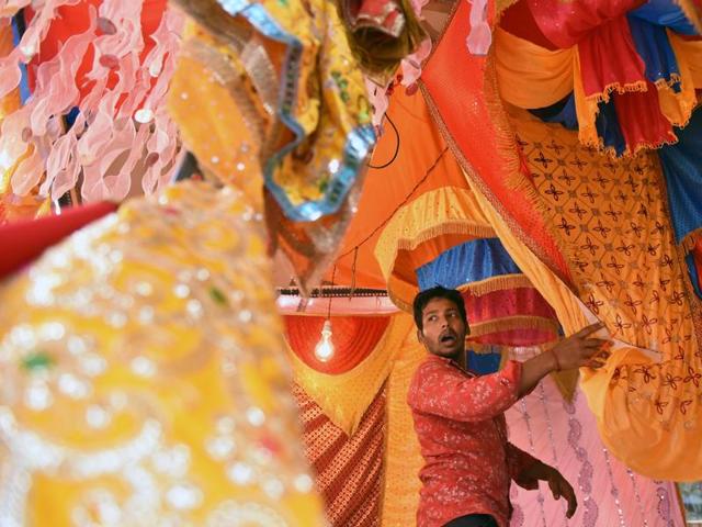 FESTIVAL OF JOY: A vendor sells colourful cloths, which will be placed on Ganpati idols,  at Dadar. (Pratham Gokhale/HT) 