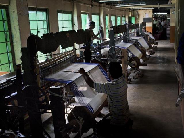 Leprosy patients who have been cured weave blue-bordered saris, worn by nuns of the Missionaries of Charity, at Gandhiji Prem Nivas, or Gandhiji House of Love, in Titagarh, north of Kolkata. (AP)