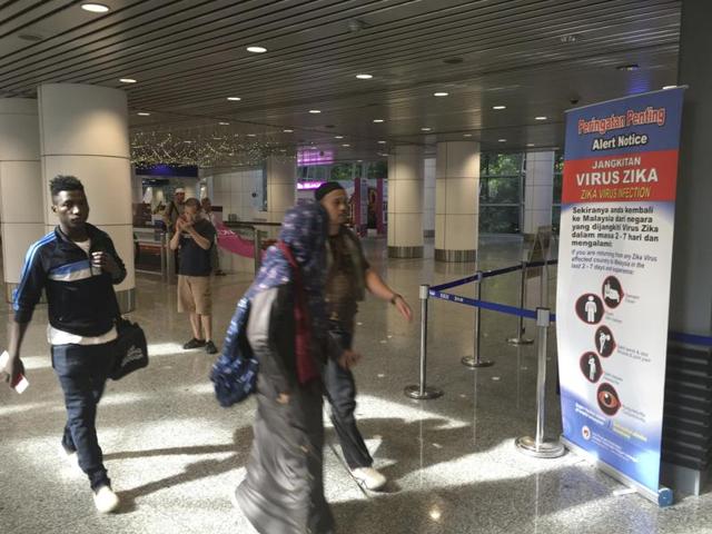 Travellers walk past a travel advisory on the Zika virus infection in Kuala Lumpur International Airport. (AP) Travellers walk past a travel advisory on the Zika virus infection in Kuala Lumpur International Airport. (AP)