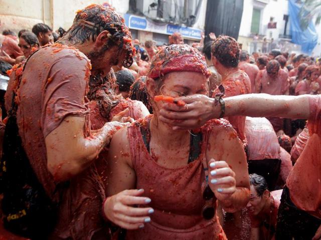 Since 1945, it has been held on the last Wednesday of August, during a week of festivities. Revellers battle with tomato pulp. (REUTERS)