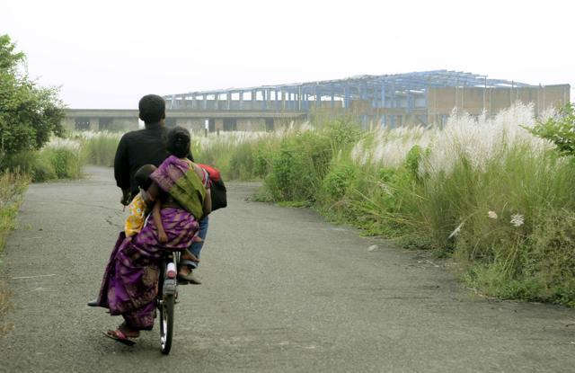 A man cycles through the factory premises on Friday. Huge and thick vegetation has covered all portions of the abandoned unit. (Ashok Nath Dey) A man cycles through the factory premises on Friday. Huge and thick vegetation has covered all portions of the abandoned unit. (Ashok Nath Dey)