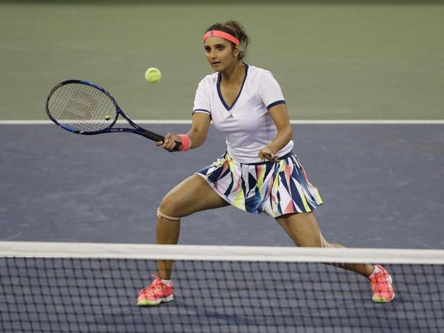 Sania Mirza, of India, returns a shot to Taylor Townsend and Donald Young during a mixed doubles match.(AP Photo)