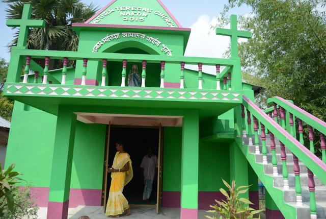 Monica Besra(L) and her husband Shelku Murmu walk out from the newly built Mother Teresa Church close to her home village of Nakur in Danogram (AFP) Monica Besra(L) and her husband Shelku Murmu walk out from the newly built Mother Teresa Church close to her home village of Nakur in Danogram (AFP)