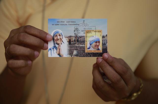 A Christian displays a commemorative postage stamp of Mother Teresa after its release function in Mumbai. (AP) A Christian displays a commemorative postage stamp of Mother Teresa after its release function in Mumbai. (AP)