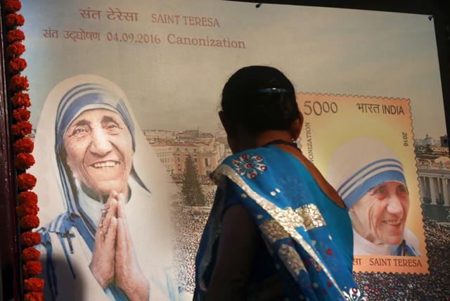 A Christian woman looks at a board displaying a commemorative postage stamp of Mother Teresa during its release. (AP) A Christian woman looks at a board displaying a commemorative postage stamp of Mother Teresa during its release. (AP)