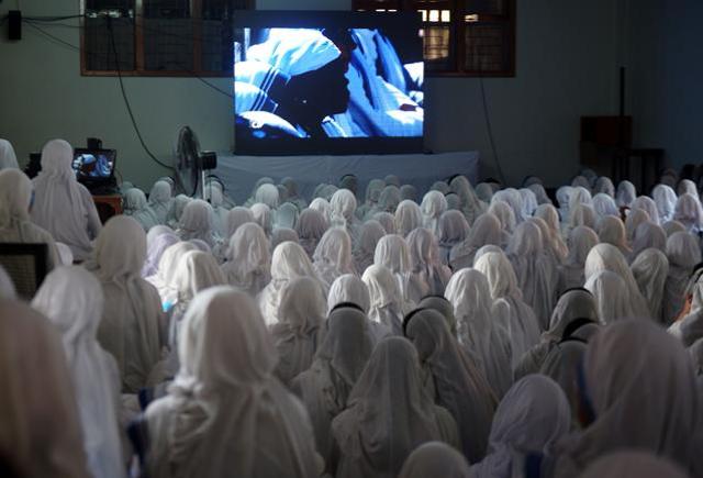Indian nuns from the Catholic Order of the Missionaries of Charity watch a live telecast of the canonisation of Mother Teresa from Rome at The Mother House in Kolkata on Sunday. (AFP) Indian nuns from the Catholic Order of the Missionaries of Charity watch a live telecast of the canonisation of Mother Teresa from Rome at The Mother House in Kolkata on Sunday. (AFP)