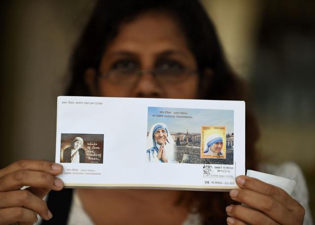 A Christian poses as she displays the commemorative postage stamp of Mother Teresa after its release. (AFP) A Christian poses as she displays the commemorative postage stamp of Mother Teresa after its release. (AFP)