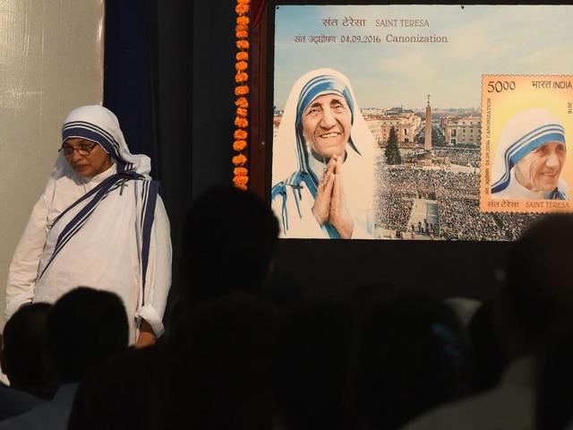 A Christian Nun stands next to a board displaying a commemorative postage stamp of Mother Teresa during its release function in Mumbai on September 4. (AFP) A Christian Nun stands next to a board displaying a commemorative postage stamp of Mother Teresa during its release function in Mumbai on September 4. (AFP)