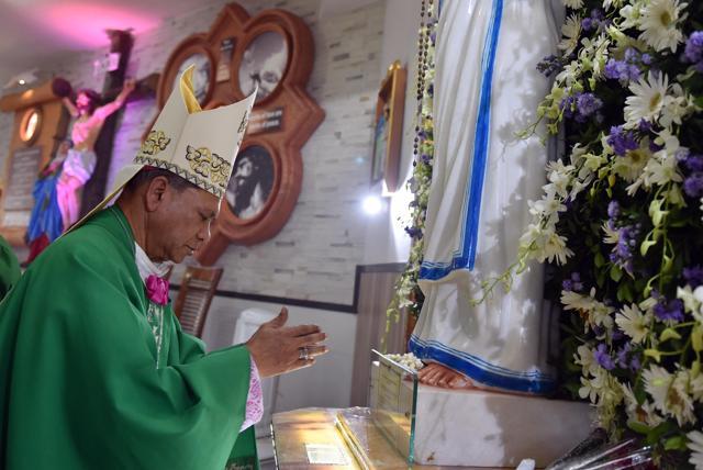 A priest prays during a mass at Saint Mother Teresa Church in Virar near Mumbai, India, on Sunday. (Pratham Gokhale/HT)
