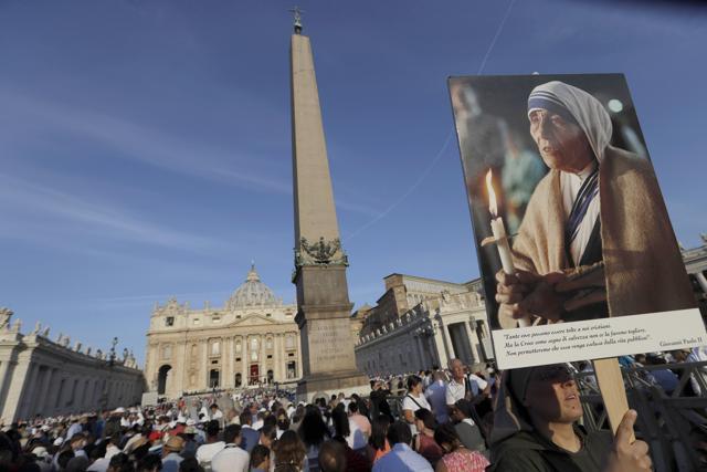 A nun holds a photo of Mother Teresa before the start of the canonisation ceremony in St. Peter's Square at the Vatican. (AP Photo) A nun holds a photo of Mother Teresa before the start of the canonisation ceremony in St. Peter's Square at the Vatican. (AP Photo)