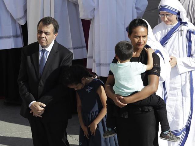 Brazilian mechanical engineer Marcilio Andrino, left, and his wife Fernanda Nascimento Rocha attend a Pope Francis' canonisation mass for Mother Teresa in St. Peter's Square at the Vatican, on Sunday. Andrino’s cure of a viral brain infection, declared a miracle by Pope Francis earlier this year, was the final step needed to declare Mother Teresa a saint.  (Alessandra Tarantino/AP) 