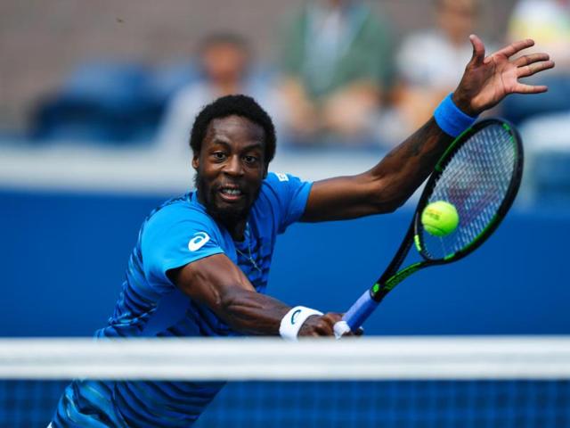 Gael Monfils of France makes a return during his win over Marcos Baghdatis of Cyprus. (AFP)