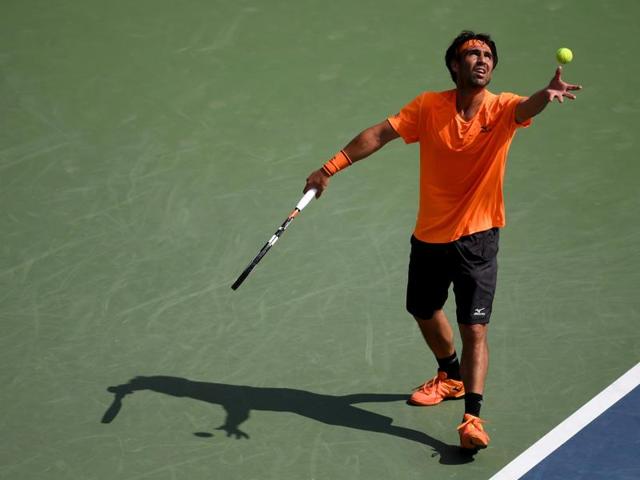 Marcos Baghdatis serves to Gael Monfils. (AFP)