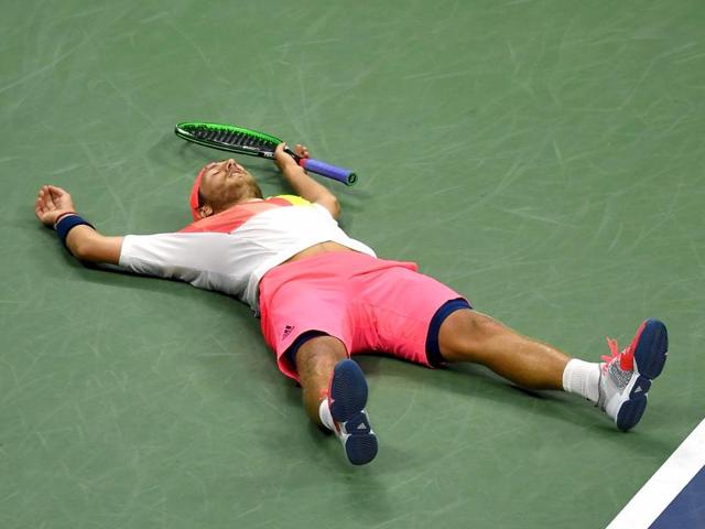 Lucas Pouille lies sprawled on the court after defeating Nadal. (AFP)