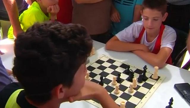 The two young players battling it out on a chess board. (Youtube screen grab) The two young players battling it out on a chess board. (Youtube screen grab)