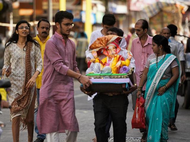 The VIP of all VIPs: This family, like hundreds of others, carry home their Ganpati early on Monday. (pratik chorge/Ht photo)