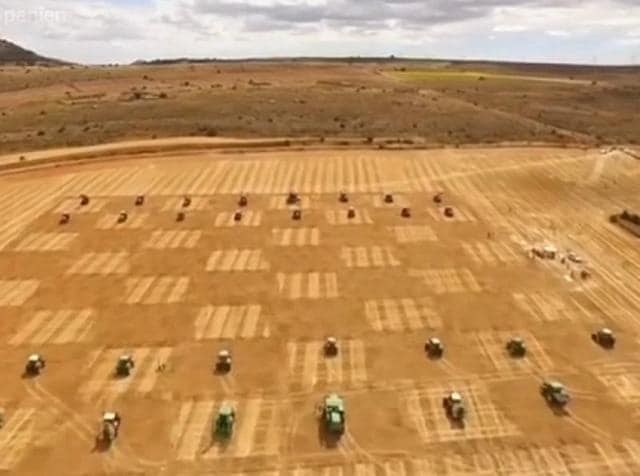 Thirty two farming machines, ranging from tractors, cultivators to harvesters stood purring on a giant chess board ready to move according to the moves made by the two young players.(Youtube screen grab)