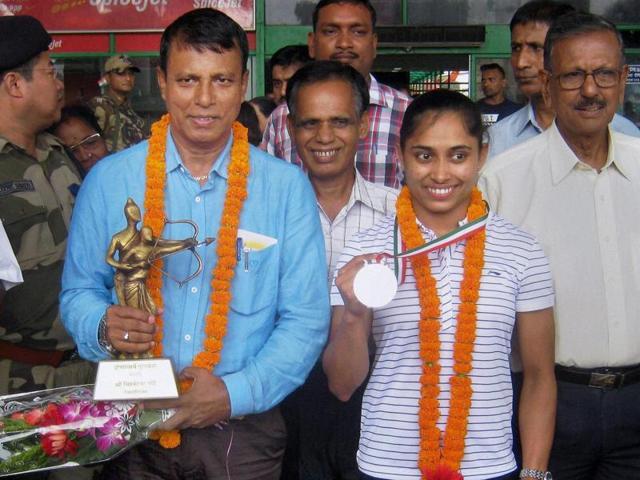 Rajiv Gandhi Khel Ratna awardee Dipa Karmakar and Dronacharya award winner coach Bishweswar Nandi welcomed on their arrival in Agartala after receiving their awards. (PTI) Rajiv Gandhi Khel Ratna awardee Dipa Karmakar and Dronacharya award winner coach Bishweswar Nandi welcomed on their arrival in Agartala after receiving their awards. (PTI)