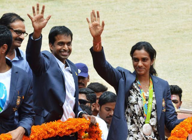 PV Sindhu (R) and her coach Pullela Gopichand wave during a felicitation parade after their return from Rio Olympics, where Sindhu won silver in singles. (REUTERS) PV Sindhu (R) and her coach Pullela Gopichand wave during a felicitation parade after their return from Rio Olympics, where Sindhu won silver in singles. (REUTERS)
