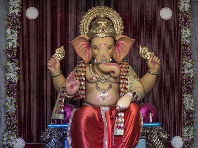 Andhericharaja as it was unveiled on Monday morning. The mandal, in its 51st year, designed its pandal as a replica of the Kunkeshwar Temple in the Konkan. (Satish Bate/HT PHOTO)