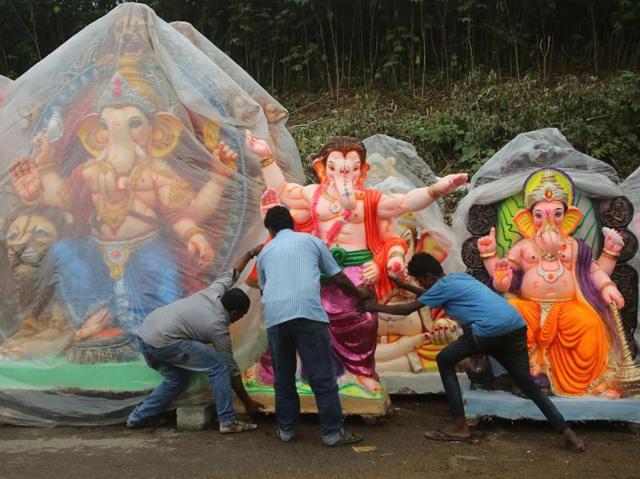 Vendors push an idol of Ganesha in Bangalore. Lord Ganesha’s idols of all sizes and in different colours and ‘avtars’ were installed in decorated ‘pandals’ or on makeshift platforms in residential neighbourhoods and commercial centres. (Aijaz Rahi/AP) 