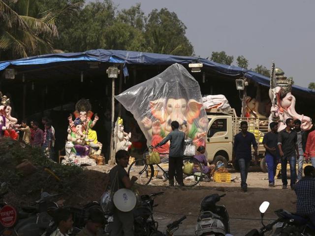 Devotees look to purchase Ganesha idols in Hyderabad. Thousands of idols have been installed in twin cities of Hyderabad and Secunderabad as well as the IT district of Cyberabad. (Mahesh Kumar A./AP) 