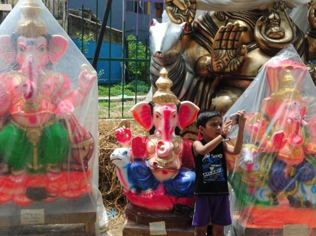 A boy takes a selfie in front of Ganesha idols in Chennai. (ARUN SANKAR/AFP) 