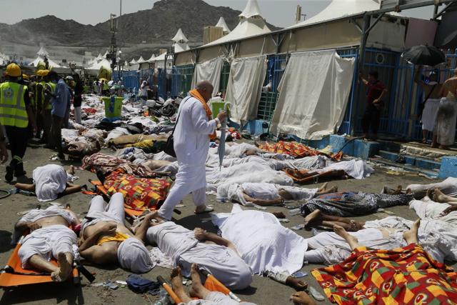 In this Sept. 24, 2015, file photo, a Muslim pilgrim walks through the site where dead bodies are gathered after a stampede during the annual hajj pilgrimage, in Mina, Saudi Arabia. (AP) In this Sept. 24, 2015, file photo, a Muslim pilgrim walks through the site where dead bodies are gathered after a stampede during the annual hajj pilgrimage, in Mina, Saudi Arabia. (AP)
