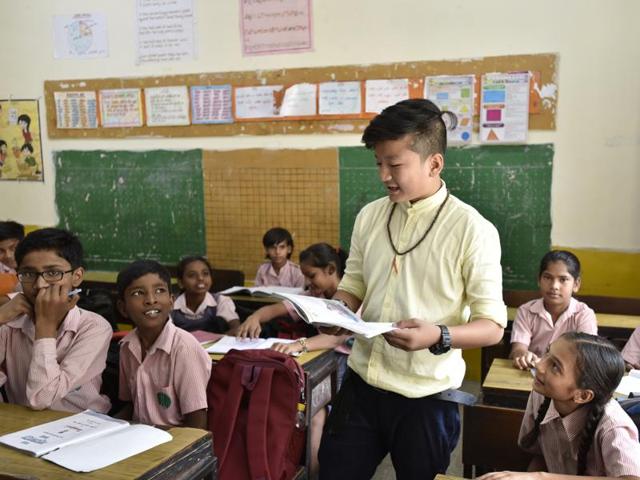 Anand Rai, a student of Class 10, teaches junior students on the occasion of Teachers’ Day at NP Co-ed Secondary School, Sangli Mess, in New Delhi on Monday. (ARVIND YADAV/HT PHOTO)