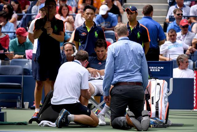 Thiem gets his knee tended to by the trainer before he decided to retire. (AFP) Thiem gets his knee tended to by the trainer before he decided to retire. (AFP)