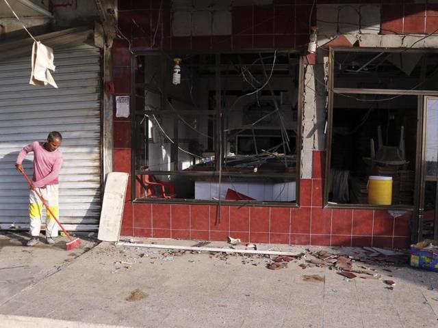 A man cleans the site of a car bomb in Baghdad. (AP) A man cleans the site of a car bomb in Baghdad. (AP)