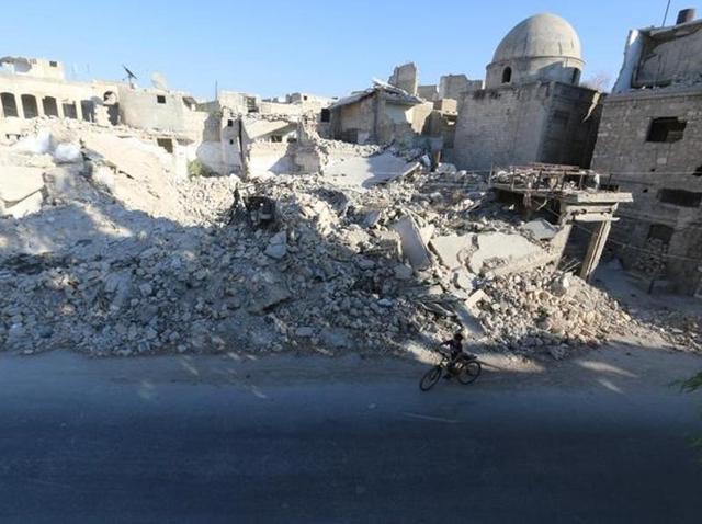 A boy rides a bicycle near rubble of damaged buildings in the rebel held al-Maadi district of Aleppo. (Reuters) A boy rides a bicycle near rubble of damaged buildings in the rebel held al-Maadi district of Aleppo. (Reuters)