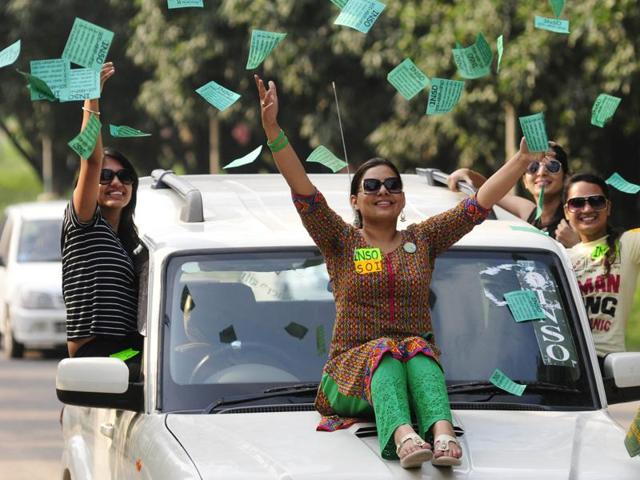 INSO-SOI alliance supporters fly the flyers at Panjab University on Tuesday. (Karun Sharma/HT Photo)
