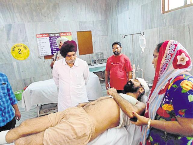 Congress MLA Tript Rajinder Singh Bajwa with the injured head constable Harpal Singh at the civil hosptal in Batala on Monday. (HT Photo) Congress MLA Tript Rajinder Singh Bajwa with the injured head constable Harpal Singh at the civil hosptal in Batala on Monday. (HT Photo)