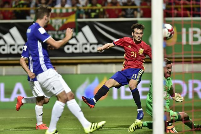 David Silva, centre, shoots past Liechtenstein's goalkeeper Peter Jehle to score. (AP) David Silva, centre, shoots past Liechtenstein's goalkeeper Peter Jehle to score. (AP)