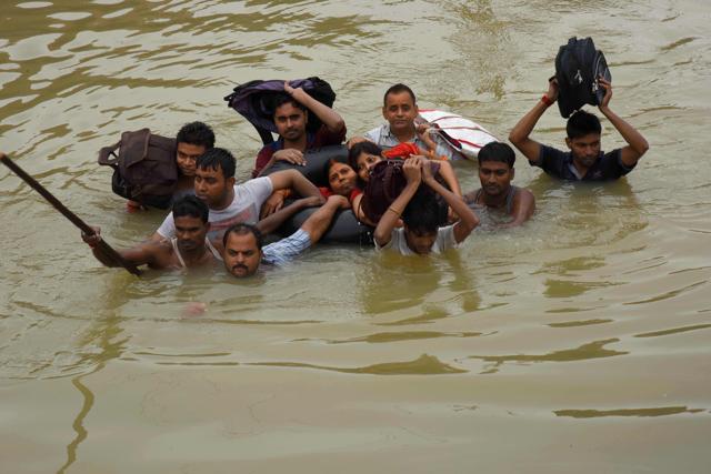 People make their way through floodwaters after rescue at Pant Nagar in Gaya on Tuesday. (AFP Photo) People make their way through floodwaters after rescue at Pant Nagar in Gaya on Tuesday. (AFP Photo)